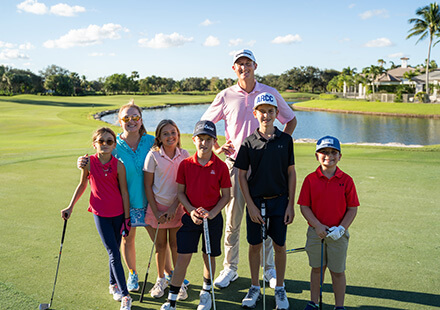 golf instructor with junior golfers