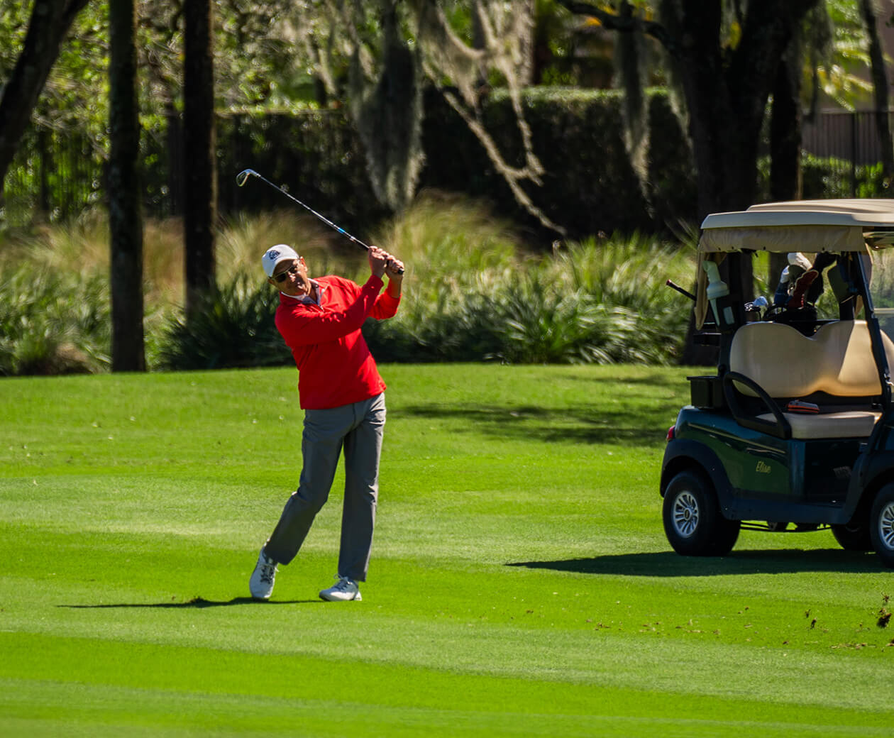 golfer and cart on course